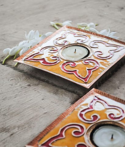 https://cdn.shopify.com/s/files/1/0649/5358/1790/products/Ekibeki-yellow-Rangoli-copper-enameled-handmade-square-Tealight-Holder-Set-of-2_2.jpg?v=1665917596